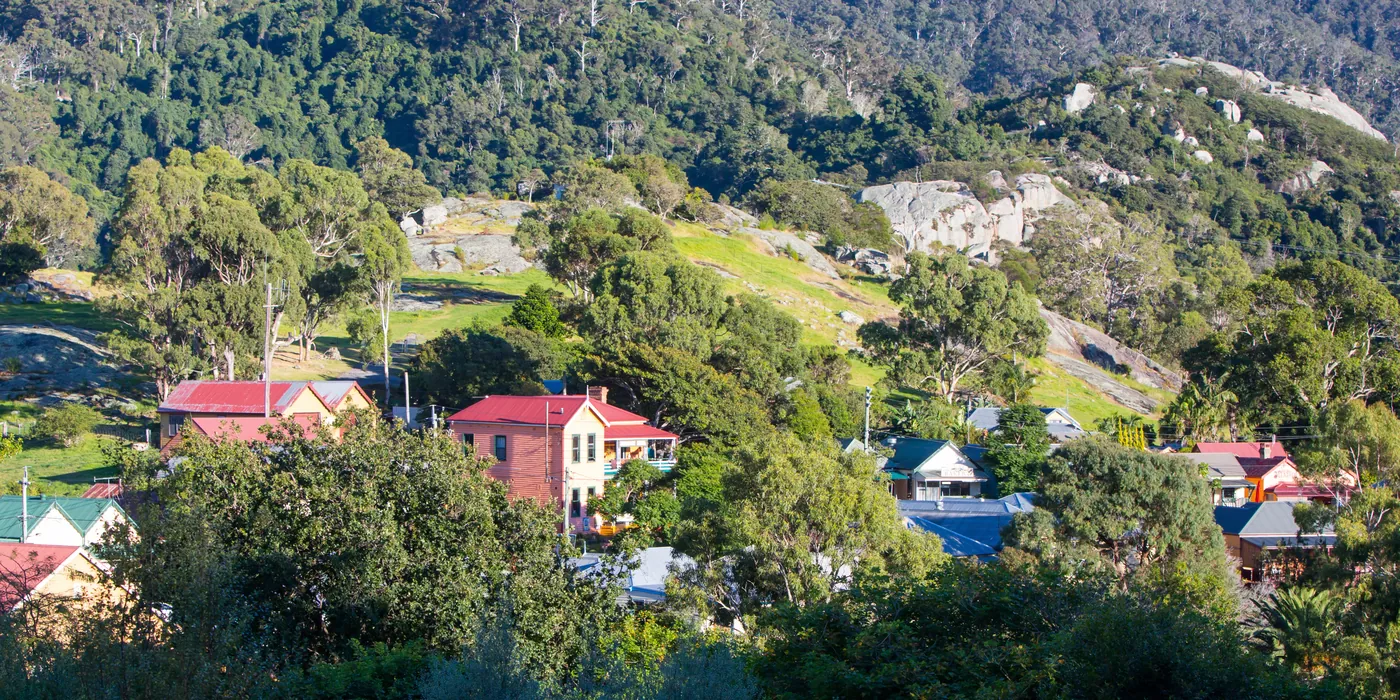 Weatherboard cottages among trees in Central Tilba on the NSW South Coast